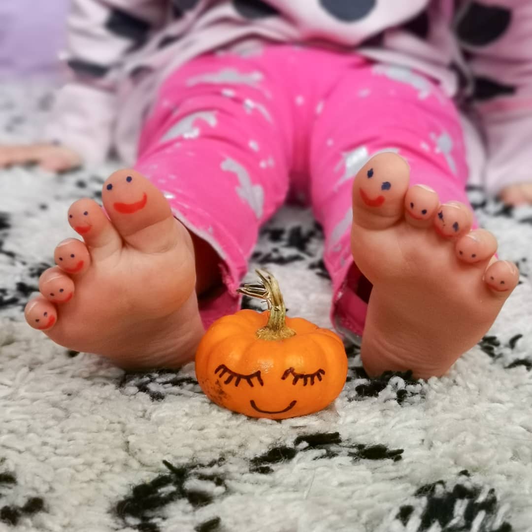 Toddler activities - drawing smiley faces on toes