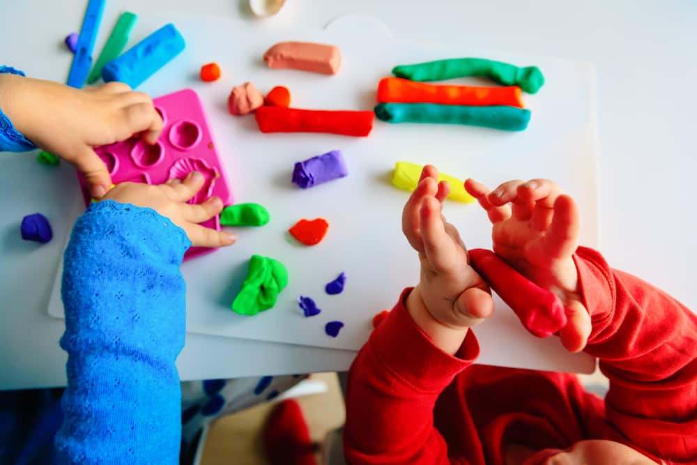 Toddler playing independently with play dough
