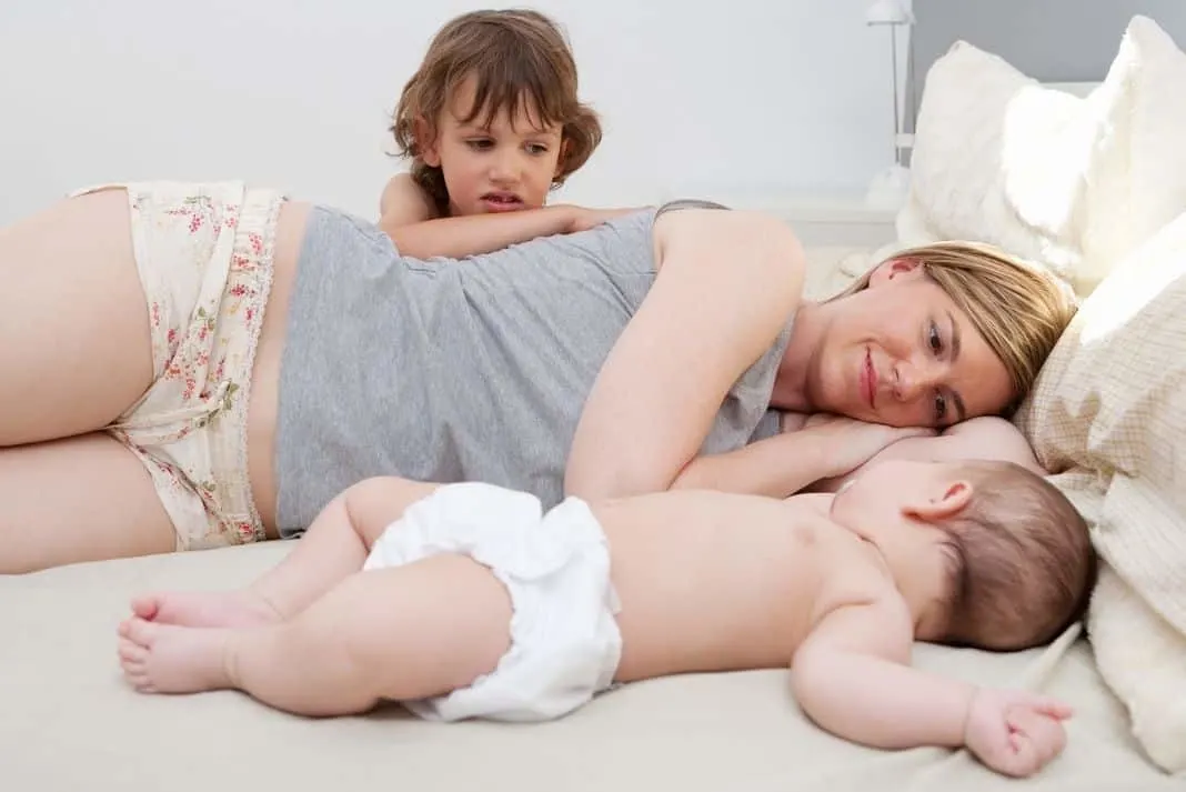 Mum with second baby and older child 