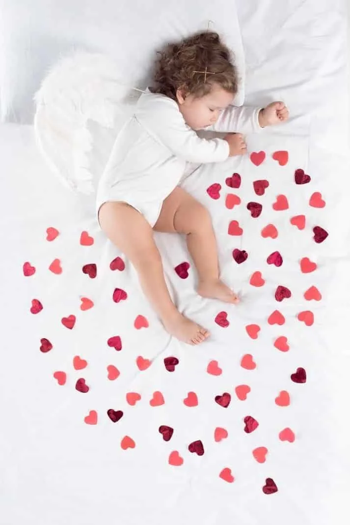 Beloved baby surrounded by hearts 