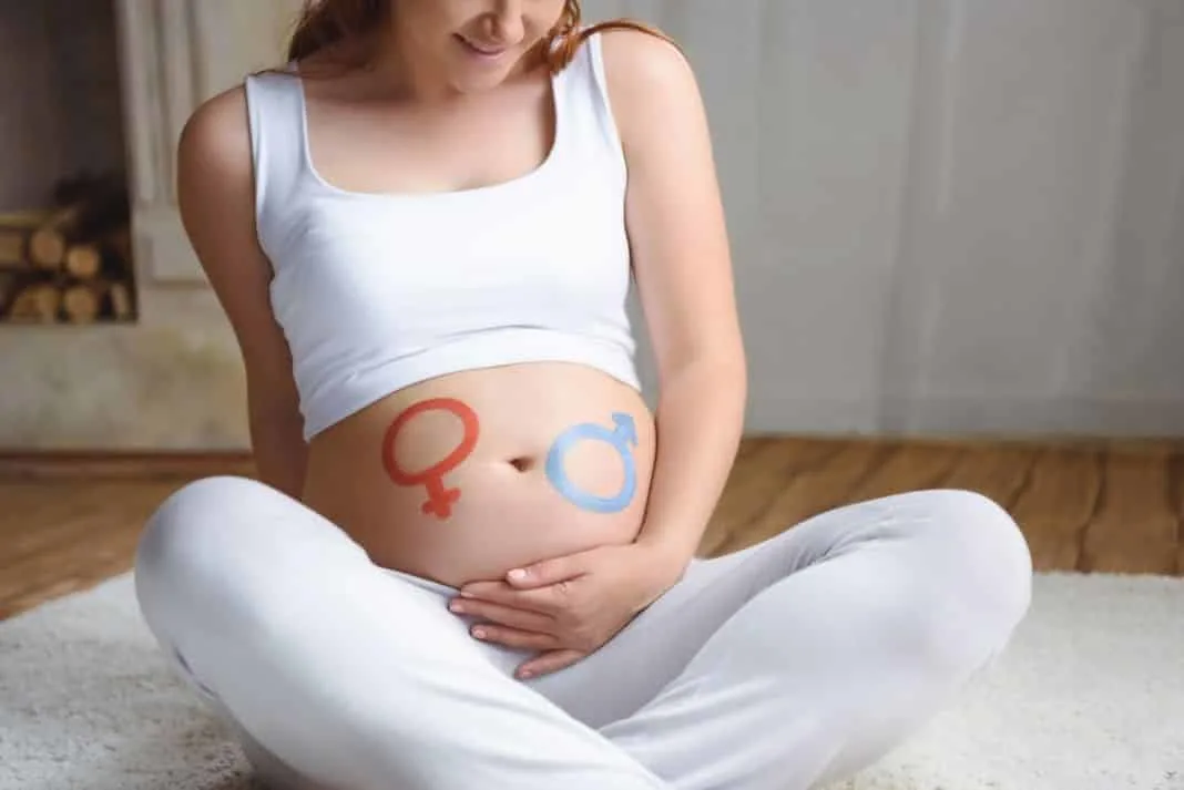 Pregnant woman considering what gender baby she is expecting